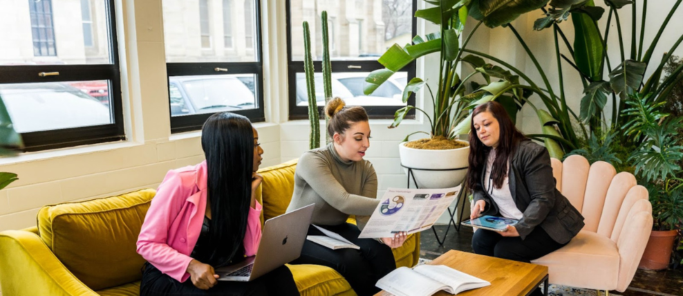 Three employees meeting together.